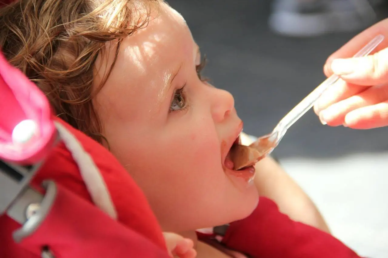 girl in red shirt eating