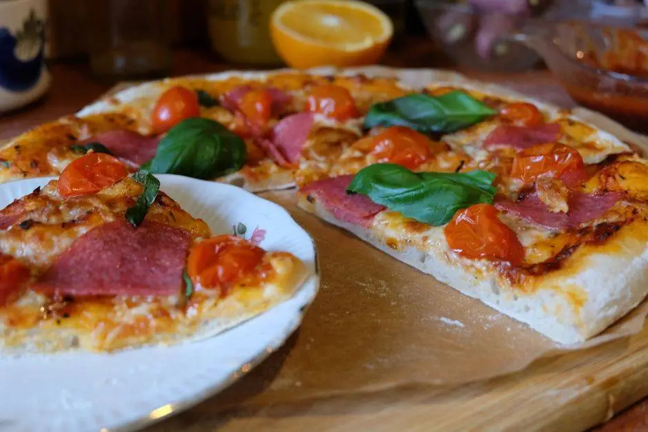 Close-up of a homemade pepperoni pizza with fresh basil and tomatoes, showcasing vibrant colors.