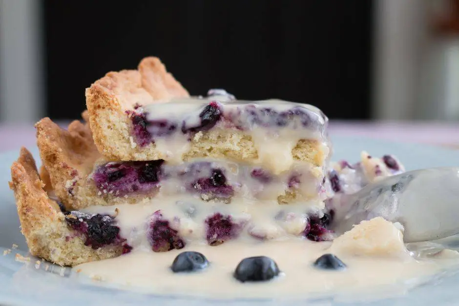 A delectable blueberry tart slice with creamy drizzle, perfect for dessert lovers.